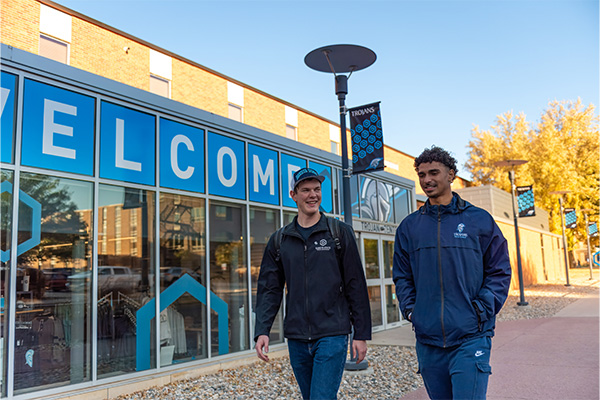 Two students walk by the Trojan Center on DSU's campus.